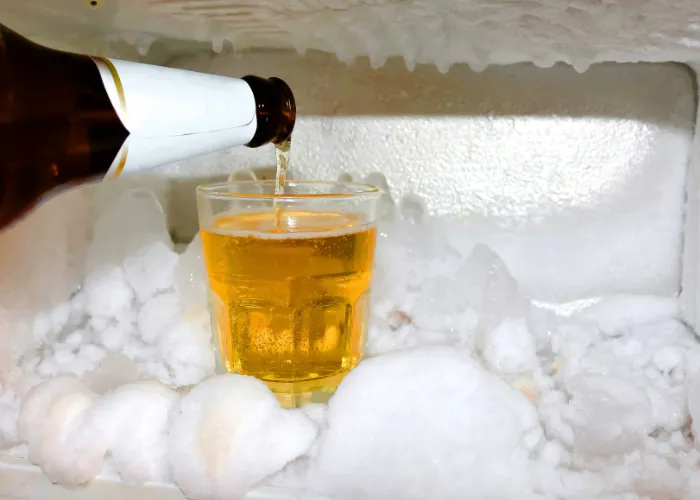 a glass of beer in a freezer