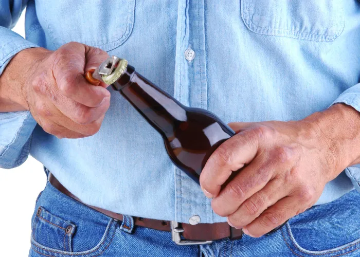 a man opening a bottle of beer
