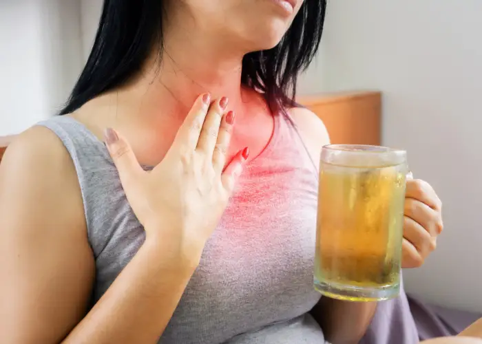 lady having acid reflux with drinking beer